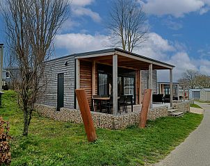 Grandeur Chalet 6 in Gulpen, South Limburg, a modern vacation home with spacious terrace and views of the green surroundings.