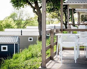 Enjoy panoramic views from the terrace of Panorama Chalet 5 in Gulpen, South Limburg, a charming vacation accommodation.